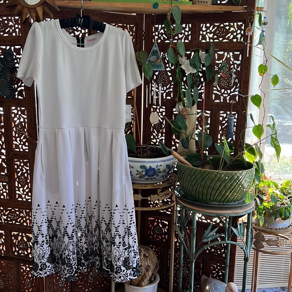 NWT LARGE Lularoe Amelia dress in white with black floral designs on the skirt.